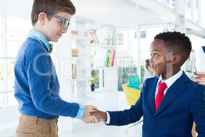 Kids as business executives shaking hands