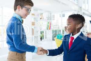 Kids as business executives shaking hands