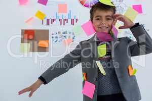 Boy as business executive with sticky notes on his body