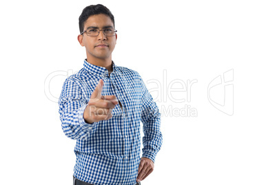 Confident man gesturing against white background