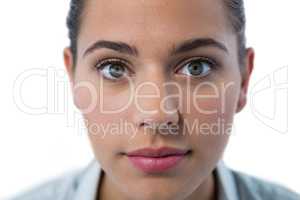 Surprised female executive standing against white background