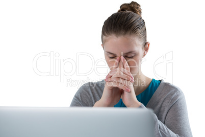 Teenage girl sitting against white background