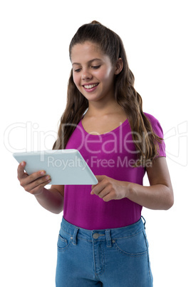 Smiling teenage girl using digital tablet
