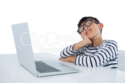 Smiling boy sitting with laptop