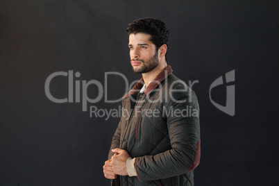 Man posing against black background