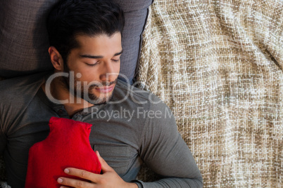 Man sleeping with hot water bag