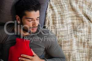 Man sleeping with hot water bag