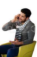 Man talking on mobile phone against white background