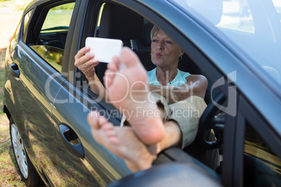 Senior woman taking selfie on mobile phone