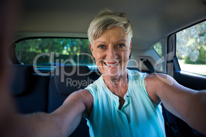 Happy senior woman inside a car
