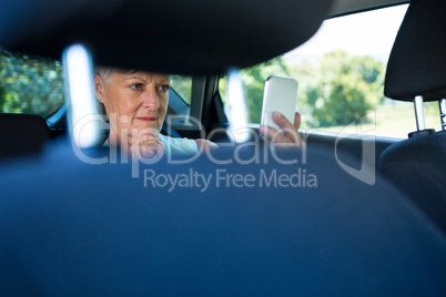 Senior woman taking selfie on mobile phone