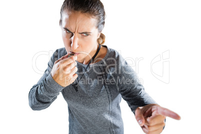 High angle view of female coach gesturing while whistling