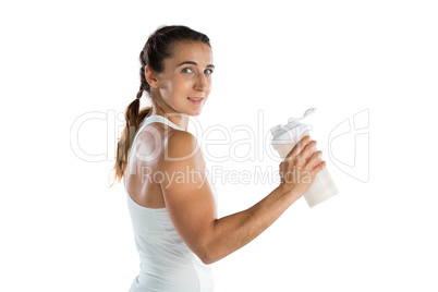 Portrait smiling female athlete holding bottle