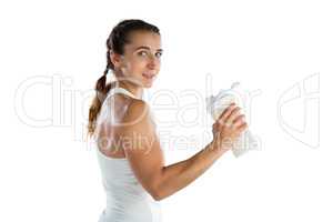 Portrait smiling female athlete holding bottle