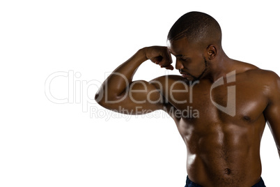 Shirtless male athlete flexing muscles