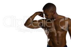 Shirtless male athlete flexing muscles