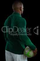 Rear view of male player holding rugby ball