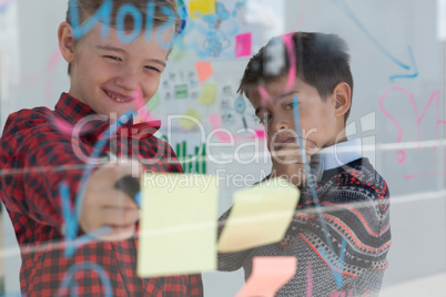 Kids as business executives discussing over whiteboard