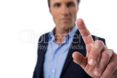 Businessman pressing an invisible virtual screen