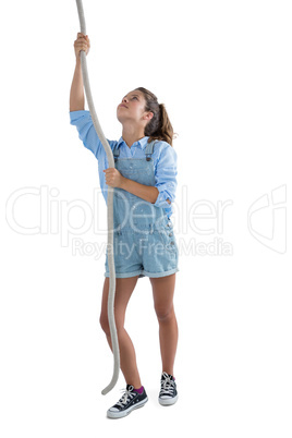 Teenage girl climbing the rope
