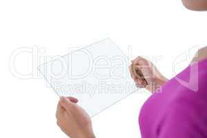 Girl using glass digital tablet against white background