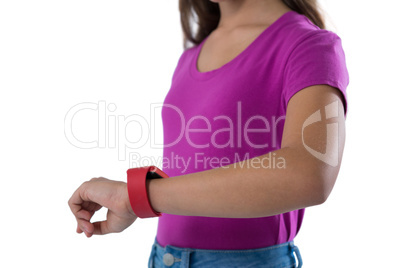 Teenage girl using smartwatch against white background