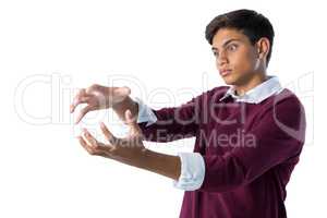 Teenage boy pretending to hold an invisible object