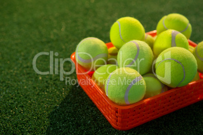 Close up of tennis balls in orange container