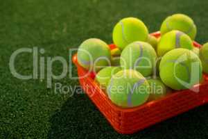 Close up of tennis balls in orange container