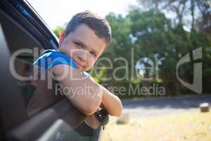 Teenage boy leaning out of car window