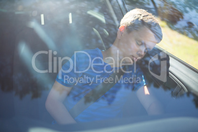 Teenage boy sleeping in the car