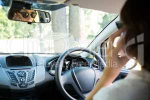 Woman talking on mobile phone while driving a car