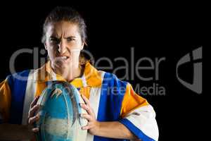 Portrait of aggressive female rugby player