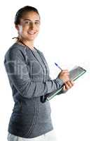 Portrait of smiling rugby coach writing on clipboard