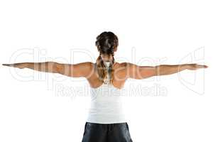 Rear view of female athlete with arms outstretched