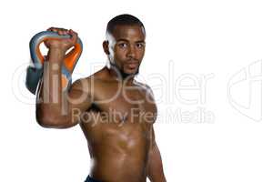 Portrait of male athlete lifting kettlebell