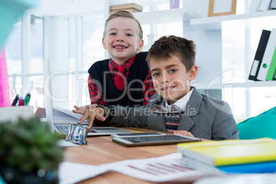 Kids as business executives using laptop