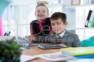 Kids as business executives using laptop