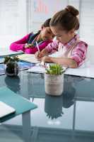 Kids as business executive writing in book