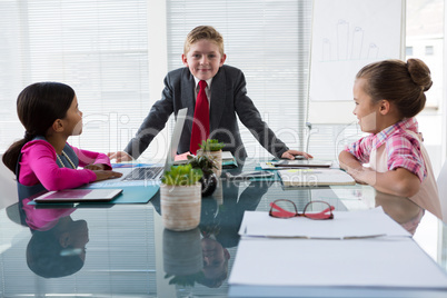 Kids as business executives interacting while meeting