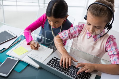 Kids as business executives working together in office