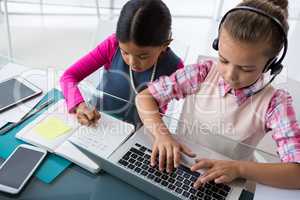 Kids as business executives working together in office