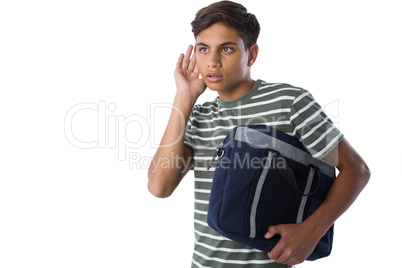 Teenage boy listening secretly with hands behind her ears