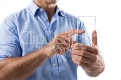 Male executive using glass mobile phone against white background
