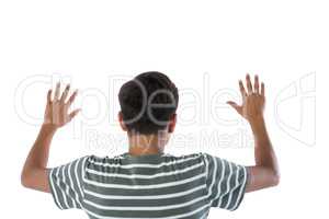 Teenage boy pressing an invisible virtual screen against white background