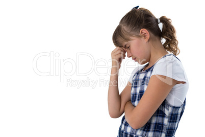 Sad girl standing against white background