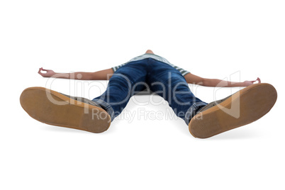 Teenage boy lying on white background