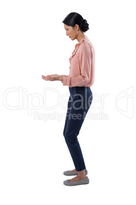 Female executive pretending to be holding invisible object