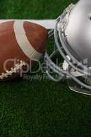 High angle view of American football by sports helmet