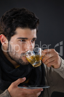 Thoughtful man having a cup of lemon tea